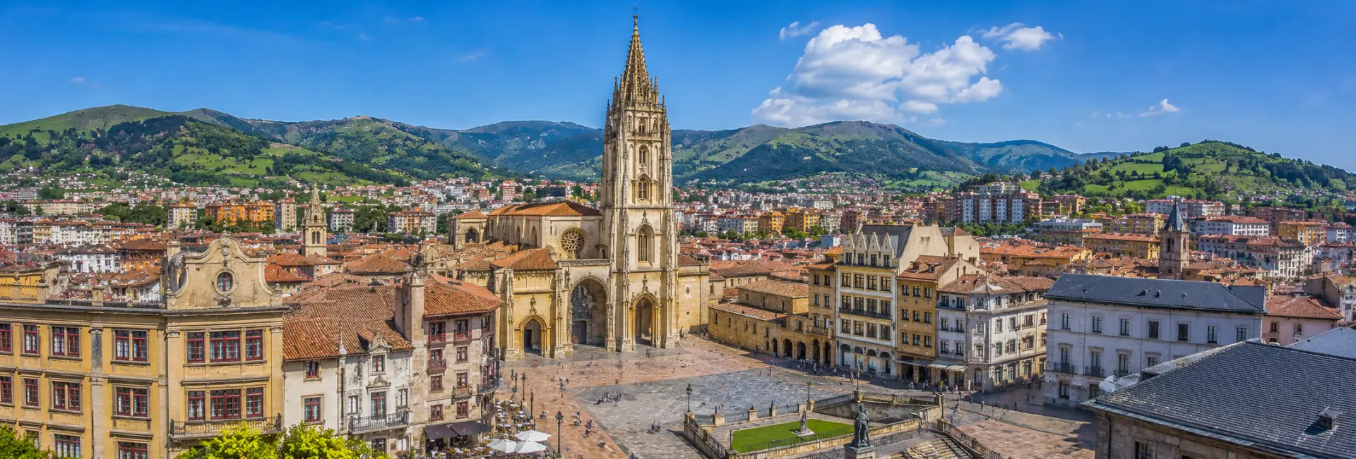 Oviedo, Spain skyline with Oviedo Cathedral, historic center and green Asturian mountains