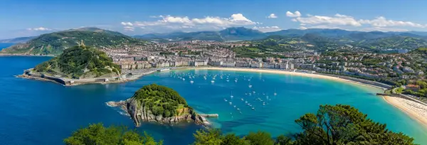 San Sebastián, Spain panoramic view of La Concha Bay, beach, waterfront and surrounding green hills