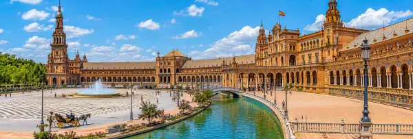 Plaza de España with its grand arches, towers, canal and fountain in Seville, Spain