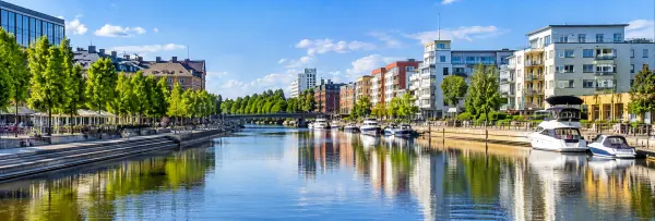 Gävle, Sweden waterfront with Gavleån, boats, tree-lined promenades and city buildings
