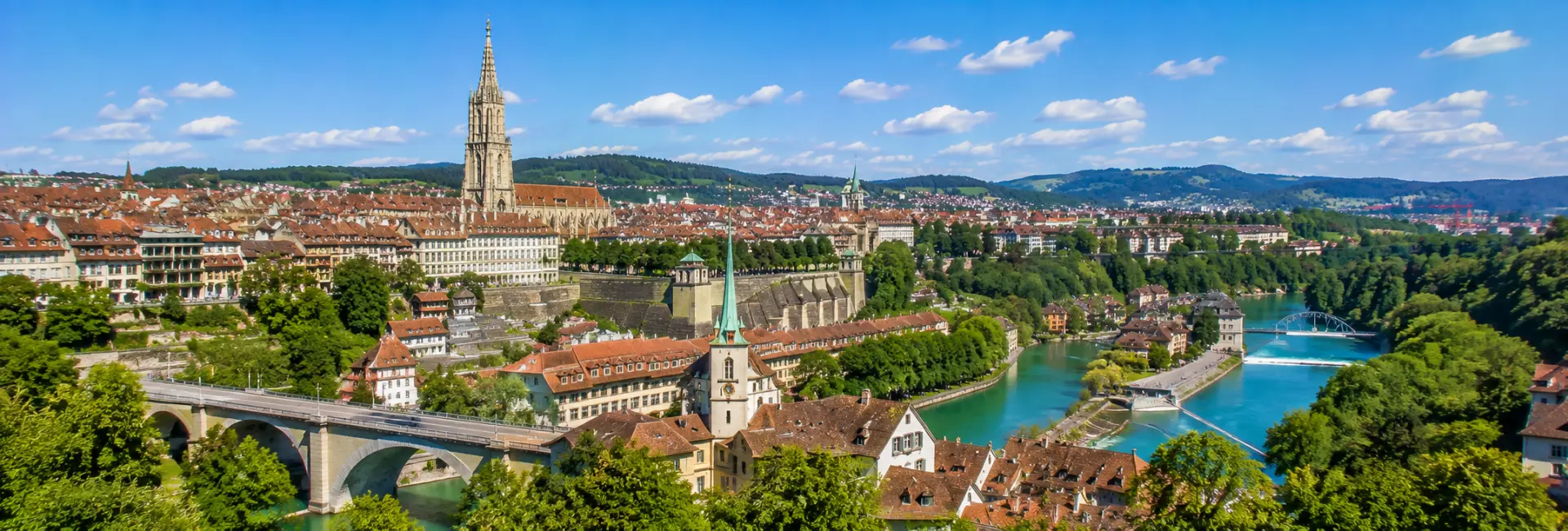 Bern, Switzerland with the historic Old Town, Bern Minster, Aare River, and red-tiled rooftops