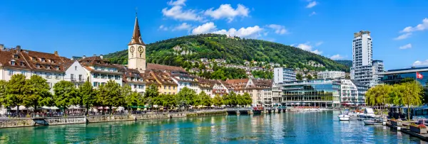 Biel/Bienne, Switzerland waterfront with historic buildings, lake views, and green hills