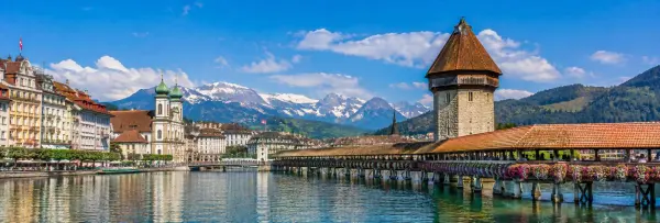 Chapel Bridge and Water Tower over the Reuss River with the Swiss Alps in Lucerne