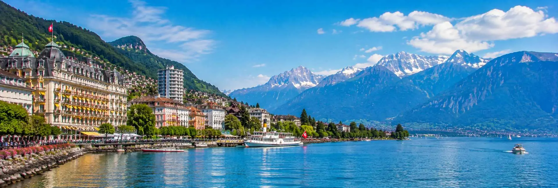 Montreux waterfront on Lake Geneva with Swiss Alps and historic lakeside buildings