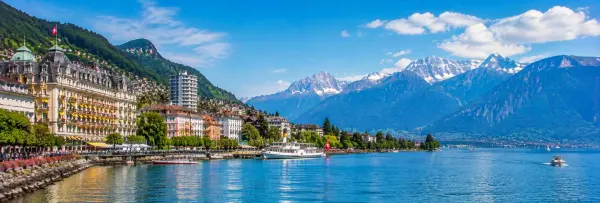 Montreux waterfront on Lake Geneva with Swiss Alps and historic lakeside buildings