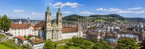 St. Gallen, Switzerland with its historic Abbey Cathedral, rooftops, and green surrounding hills