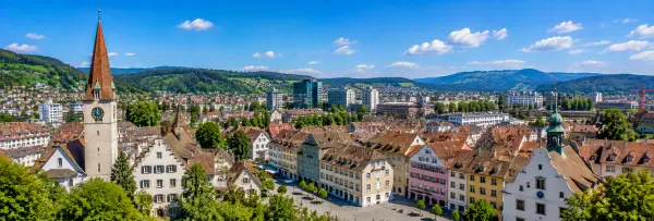 Winterthur, Switzerland with historic buildings, church towers, red rooftops, and green hills