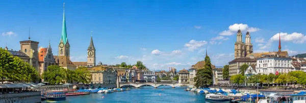 Zurich cityscape along the Limmat River with historic buildings and church towers