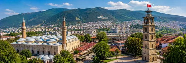 Bursa Grand Mosque and historic city center with Uludağ mountains in Türkiye