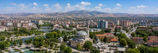 Malatya, Türkiye skyline with a historic mosque, green parks, waterways, and surrounding mountains
