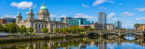 Belfast City Hall and historic architecture overlooking the River Lagan in Belfast, UK