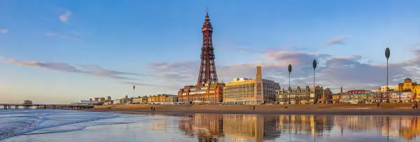 Blackpool Tower and seaside promenade viewed from the beach in Blackpool, United Kingdom