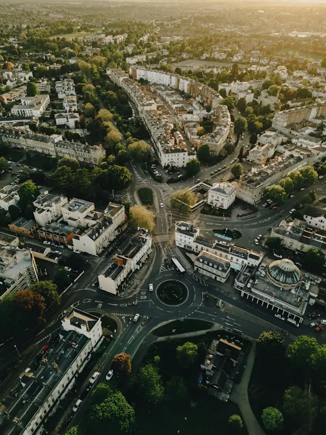 Aerial view of Cheltenham showing leafy streets, historic buildings and busy roundabouts