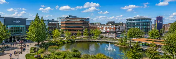 Crawley, United Kingdom town centre with County Mall, fountain plaza, modern buildings and greenery