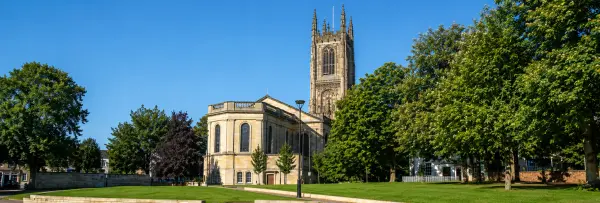 Derby Cathedral and historic church tower surrounded by greenery in Derby, England