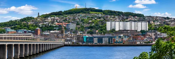 Dundee city skyline, waterfront and Dundee Law hill viewed across the River Tay in Dundee, UK