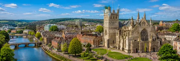 Exeter, United Kingdom cityscape with Exeter Cathedral, River Exe and historic buildings