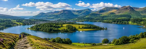 Scenic view of a lake surrounded by green hills and mountains in the Lake District, UK