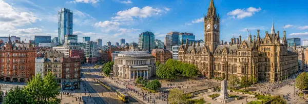 Manchester, England panoramic city centre view with historic Town Hall and modern skyline