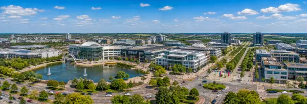 Milton Keynes, United Kingdom skyline with modern buildings, lake, fountains, and tree-lined roads