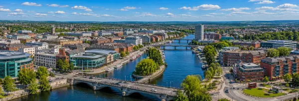 Aerial panoramic view of Reading, United Kingdom, with the River Thames, bridges, historic buildings, and city skyline