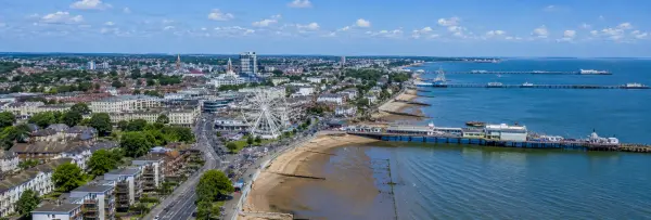 Aerial panoramic view of Southend-on-Sea, United Kingdom, with the seafront, Southend Pier, beach, and Ferris wheel