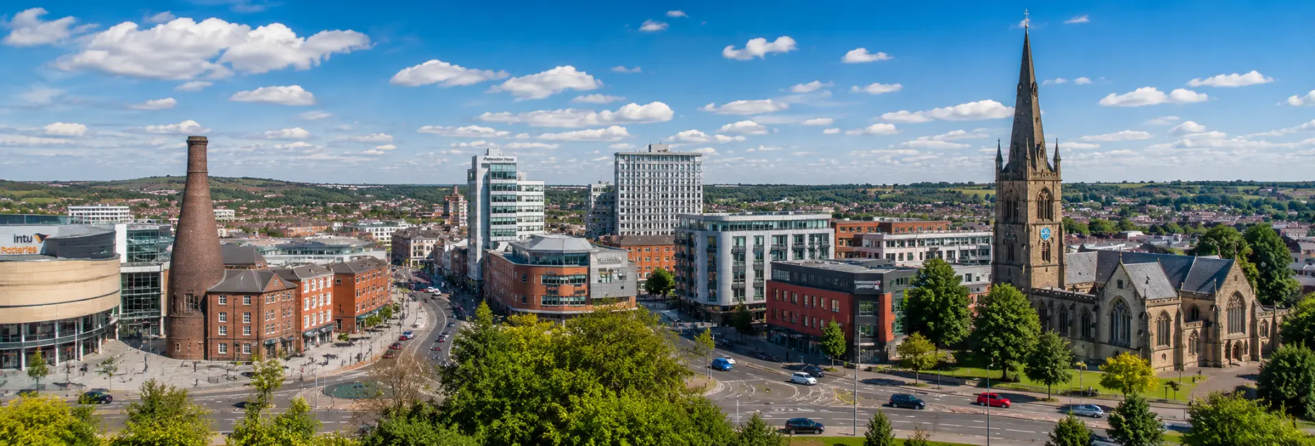 Stoke-on-Trent, United Kingdom skyline with historic buildings, church spire, and urban streets