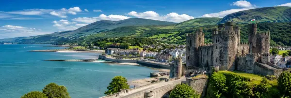 Wales, UK scenic medieval castle overlooking the coast and lush green mountains