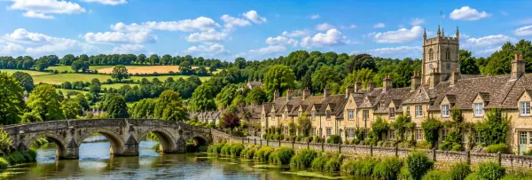 Picturesque Wiltshire village with honey-colored cottages, a historic stone bridge and rolling countryside